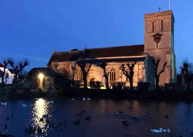 The church and pond at the village green of Haddenham in Bucks, UK.